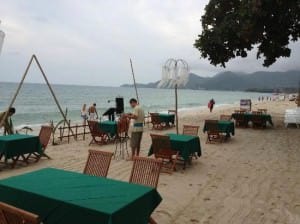 Buri Rasa Village Hotel setting up chairs and tables on the beach for food