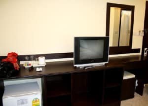 @ White Patong Hotel other side of bedroom with TV and fridge